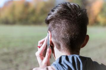 A picture of a person making a call on a mobile phone