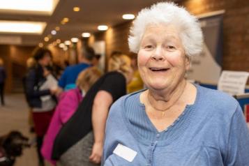 older lady with other women in the background 