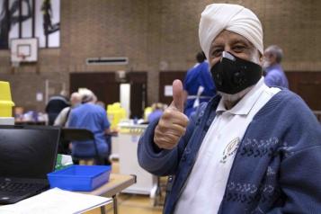 man wearing mask in vaccine centre 