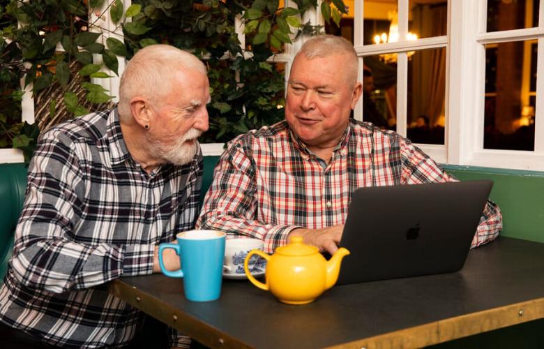 Two men on a laptop