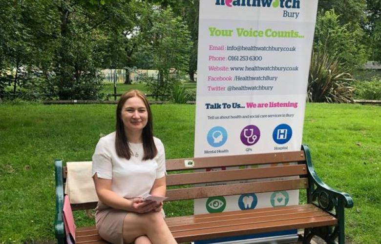 Healthwatch staff member sat on park bench 